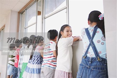 Children Looking Out Through A Window