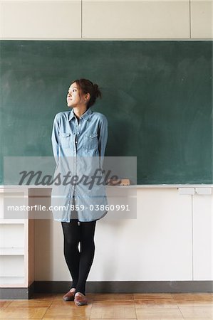 Female Standing In Front Of Blackboard