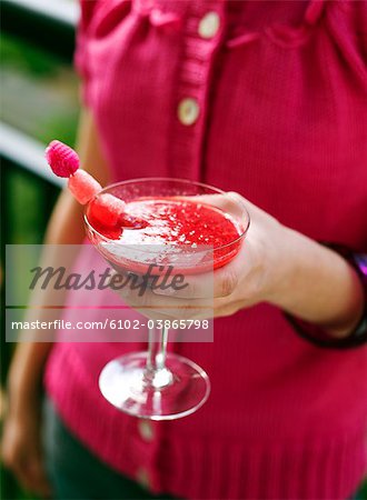 A woman holding a drink, Sweden.