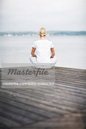 A woman sitting on a jetty, Sweden.