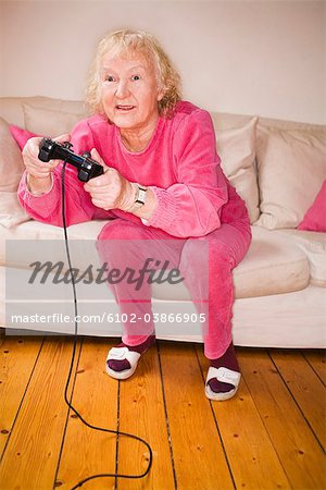 An elderly woman playing a video game, Sweden.