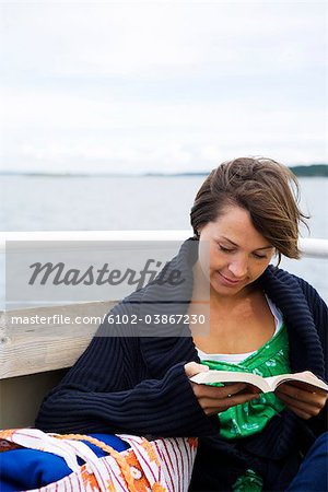 A scandinavian woman in a boat in the archipelago, Sweden.