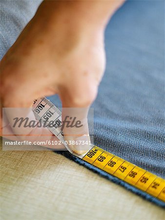Tailor using measuring-tape, Sweden.