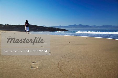 Woman walking on beach, Plettenberg Bay, Western Cape, South Africa, Africa
