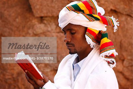 Faithful reading outside a church in Lalibela, Ethiopia, Africa