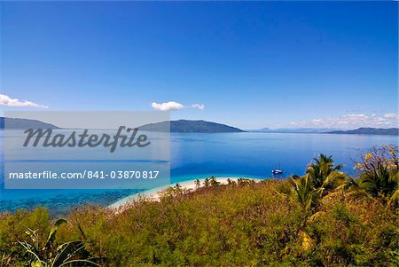 Crystal clear water and white sand beach, in the background Nosy Komab, Nosy Be, Madagascar, Indian Ocean, Africa