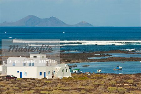 Rock pools and Graciosa Island beyond, near Orzola at the north east tip of the island, Lanzarote, Canary Islands Spain, Atlantic, Europe