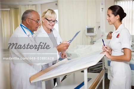 Médecins avec l'infirmière en salle d'hôpital