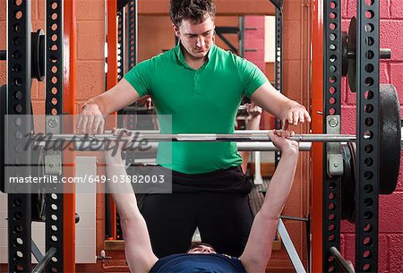 Men lifting weights in gym