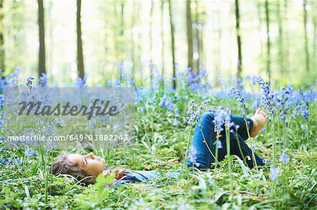 Girl laying in field of flowers