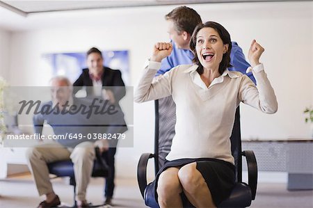 Business people having chair race