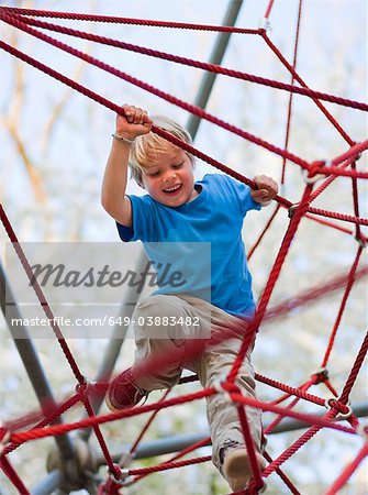 Boy climbing at playground