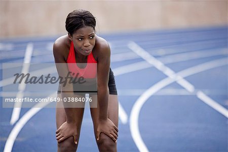 Woman resting on running track