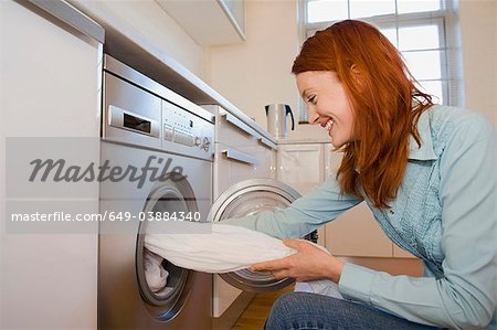Woman unloading washing machine