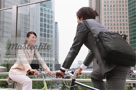 Businesspeople Commuting On Bicycle