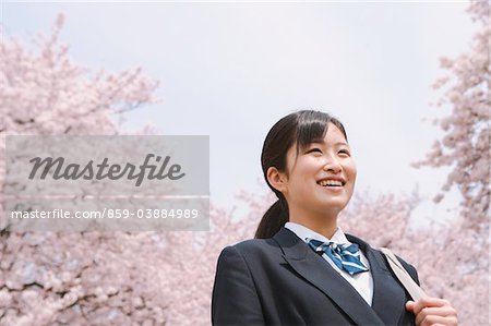 High School Girl Smiling In Cherry Blossoms