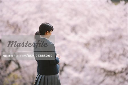 High School Girl Looking At Cherry Blossom Trees