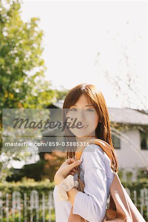 Japanese Women Smiling And Carrying Handbag