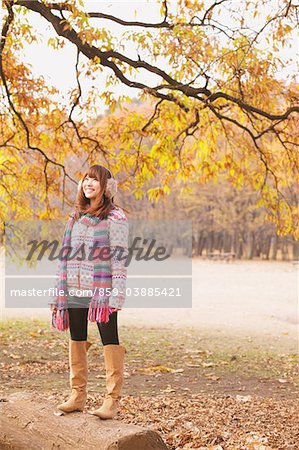 Japanese Women Standing On Ginkgo Tree-Trunk Under Tree Branches