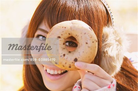 Japanese Women Looking Through Donut