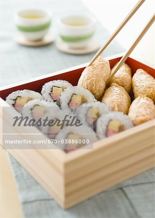 Sushi roll et inari sushi en boîte déjeuner Sushi roll et inari sushi en boîte déjeuner