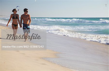 Young couple walking on Floreat beach, Perth, Western Australia, Australia