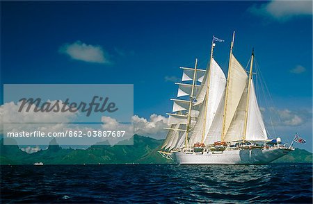 French Polynesia, Society Islands, Leeward Islands, Moorea, aka Aimeho. Star Flyer, a four-masted barquentine and part of the Star Clippers cruise line, sails off the coast of Moorea.