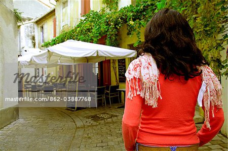 Arles; Bouches du Rhone, France; A girl standing in one of the typical streets in town.