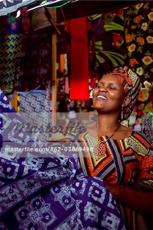 Kigali, Rwanda. A woman sells traditional fabric in Kimironko market.