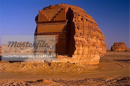 Saudi Arabia, Madinah, nr. Al-Ula, Madain Saleh (aka Hegra). Now a UNESCO World Heritage Site, the ancient remains of Qasr al-Farid - a rock-cut tomb and part of an ancient Nabatean settlement - stands amidst imposing cliffs and striking rocky outcrops.