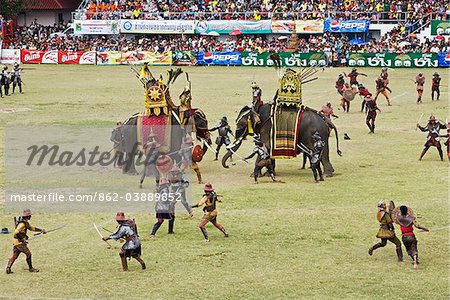 Thailand, Surin, Surin.  Soldiers battle in an ancient war re-enactment during the Elephant Roundup festival.  The event held in November sees hundreds of elephants involved in a celebration of the region's proud elephant history and traditions.