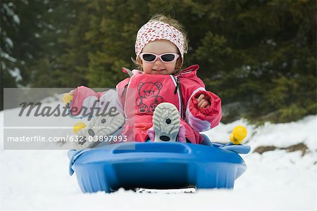 Toddler girl on sled