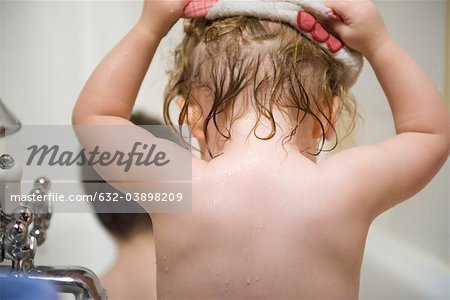 Baby girl taking a bath, rear view