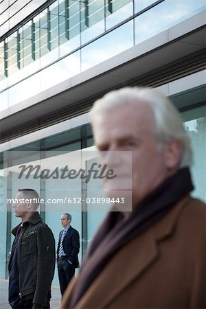 Businessmen standing in front of building