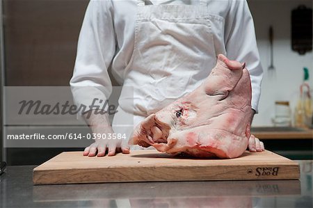 Butcher with head of pig