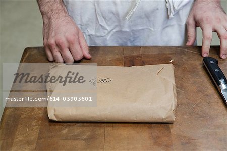Butcher with package of ribs