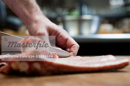 Butcher preparing pork ribs