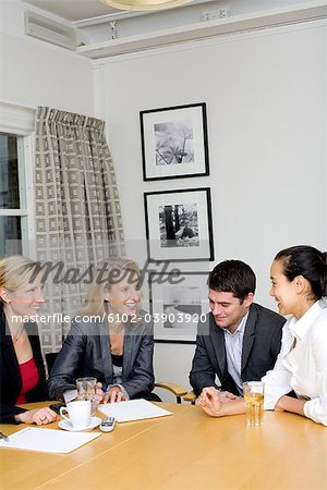 Four people sitting at a table, Sweden.