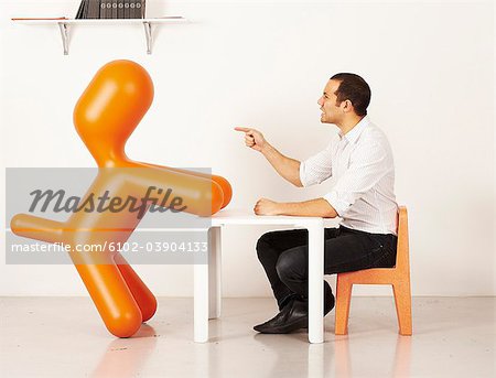 Man interacting with a plastic dog, Sweden.
