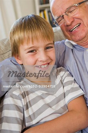 Grandfather and grandson in a sofa, Sweden.