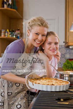 Mother and daughter with a freshly baked pie, Sweden.