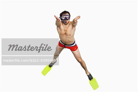 Young man with diving flippers and goggles.