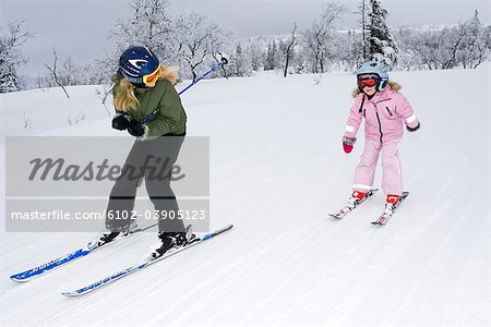 Two sisters doing slalom-skiing, Sweden.