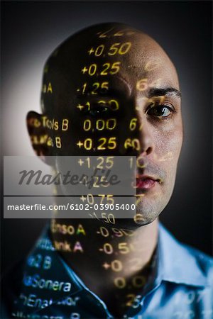 A man with the stock-exchange quotation reflected on his face.