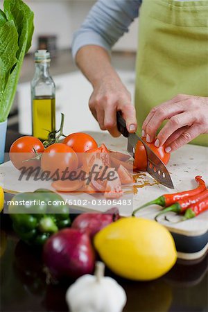 Woman cutting up vegetables, Sweden.