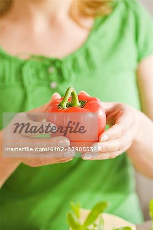 Woman holding a pepper, Sweden.