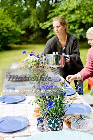 Women preparing dining table