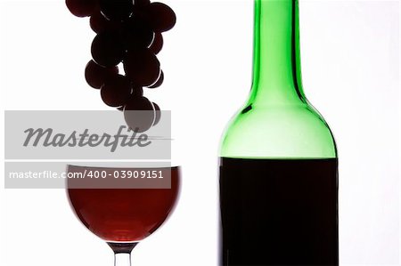 Red wine and grapes in wihte background.