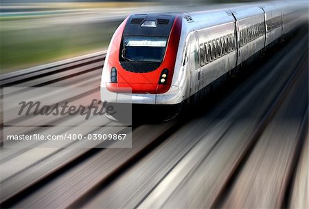 Train speeding along its tracks with motion blur.