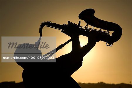 A saxophonist playing on the beac in Famara in Lanzarote